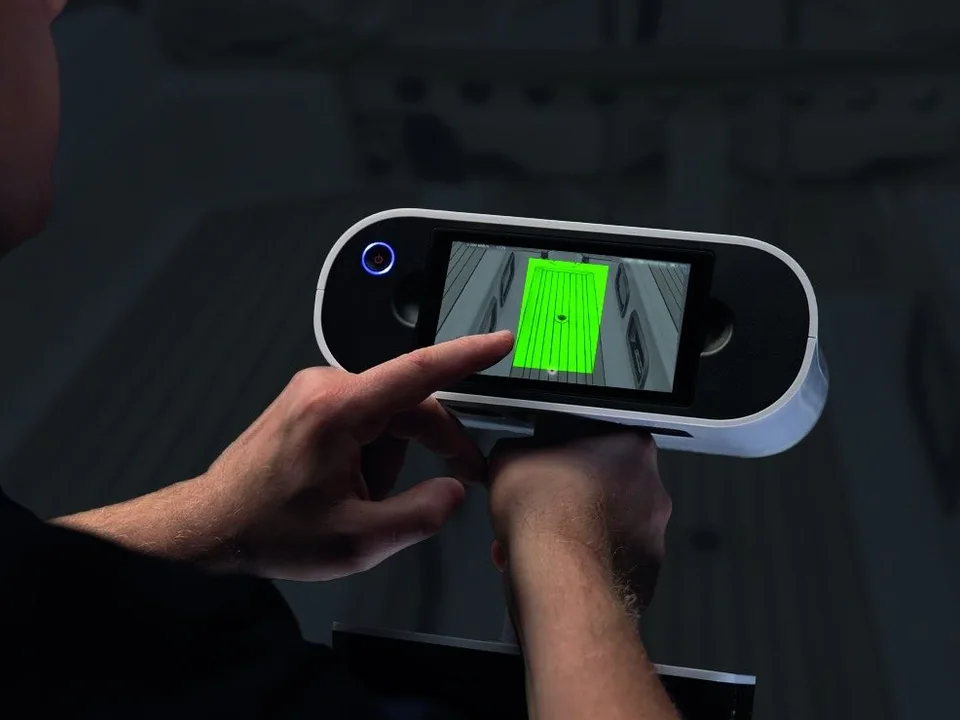 Technician measuring a yacht deck on board with a portable 3D laser scanner